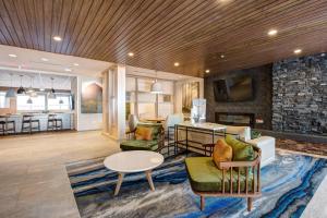 a living room with a couch and a table at Fairfield Inn & Suites Minneapolis North in Brooklyn Center