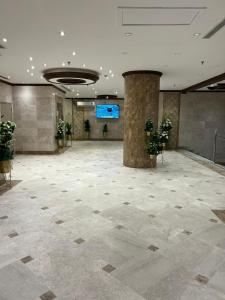 a large lobby with a large room with plants at ضيف المشاعر in Makkah