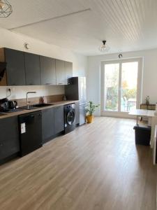 a large kitchen with a sink and a washing machine at Maison de village -Luberon - Villelaure in Villelaure