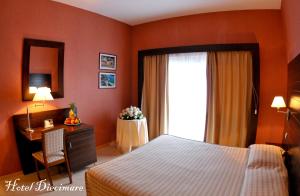 Säng eller sängar i ett rum på Hotel Diecimare