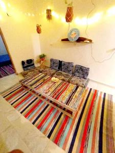 a room with a bed with a colorful rug at Bougainvillea studio in Dahab