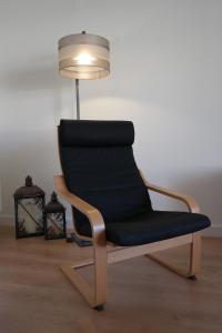 a black chair sitting next to a lamp at Vila Atlantida Apartment in Vilamoura