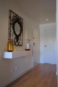 a white room with a mirror and a door at Vila Atlantida Apartment in Vilamoura