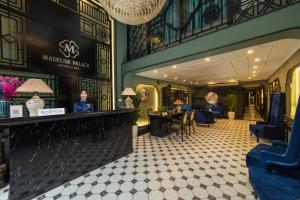 a lobby of a restaurant with a counter and chairs at Madelise Palace Hotel & Spa in Hanoi