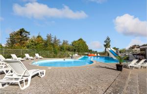 a swimming pool with lounge chairs and a slide at 2 Bedroom Gorgeous Home In Humble in Humble