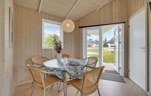 a dining room with a glass table and chairs at 2 Bedroom Gorgeous Home In Humble in Humble