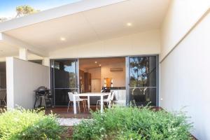 a glass extension of a house with a table and chairs at Eight Willows Retreat in Margaret River Town