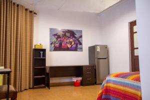 a room with a refrigerator and a bed in it at Departamento Rustico 1 in Tarija