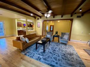 a living room with a couch and a table at Newer Ranch with Pool and Hot Tub near the Strip and Freemont street. in Las Vegas