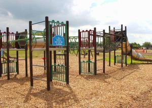 a playground with a slide in a park at Bosworth Lakeside Lodges 