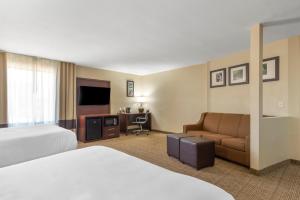 a hotel room with a bed and a couch at Comfort Suites Locust Grove Atlanta South in Locust Grove