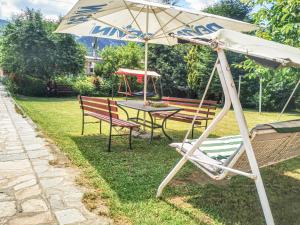 a hammock and an umbrella and a table and chairs at Apartments Dream in Sarnitsa