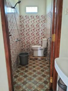 a bathroom with a toilet and a shower at Bromo Seruni Astungkara Homestay in Probolinggo
