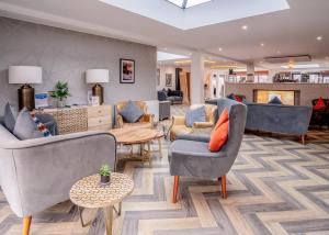 a living room with couches and chairs and a table at Crofthead in Ayr