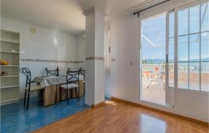 a dining room with a table and a large window at Gorgeous Apartment In Puente De Genave With Sauna in Puente de Génave