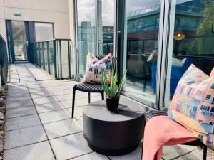 a patio with a chair and a potted plant at Charming Duplex in Grand Canal in Dublin