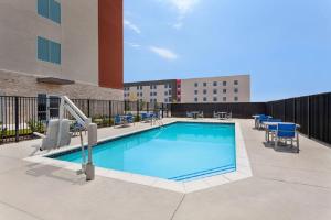 a swimming pool on a rooftop of a building at Holiday Inn Express & Suites Austin North - Pflugerville, an IHG Hotel in Pflugerville