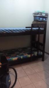 a bunk bed in a room with a desk at Morada Kampos in Heredia +17 photos