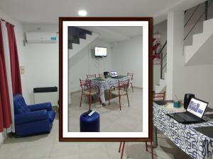a mirror in a room with a table and a blue chair at Cabañas Florida Del Sur in San Rafael