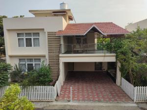 a house with a balcony in front of it at Tulip Serviced Villa in Chennai