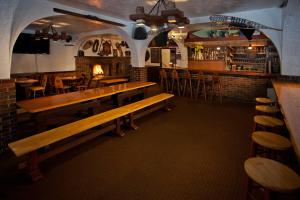 a restaurant with wooden benches and a bar at Crystal Mountain Hotels in Crystal Mountain