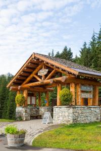 a log cabin with a sign in front of it at Crystal Mountain Hotels in Crystal Mountain