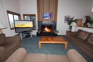 a living room with a fireplace and a television at 1228 Timber Lane home in South Lake Tahoe