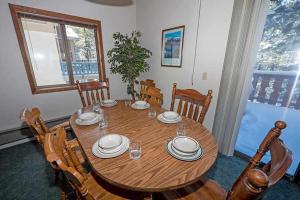 a dining room table with chairs and a wooden table and chairsktop at 1228 Timber Lane home in South Lake Tahoe