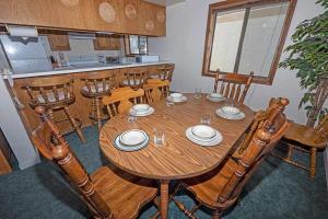 a wooden table in a kitchen with chairs and a table at 1228 Timber Lane home in South Lake Tahoe +12 photos