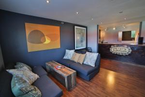 a living room with a couch and a table at Motel 6 - Las Vegas, NV – Downtown Fremont St Experience in Las Vegas
