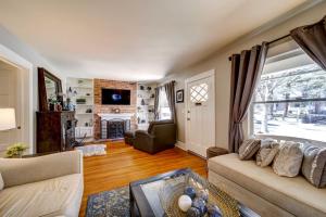 a living room with a couch and a fireplace at Historic Prescott Home with Yard and Fire Pit! in Prescott