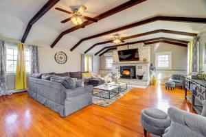 a living room with a couch and a fireplace at Grand Home with Game Room - 16 Mi to Kalahari! in Gouldsboro