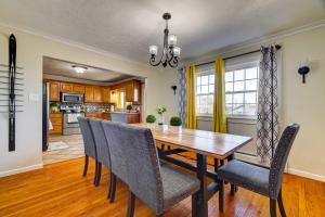 a kitchen and dining room with a wooden table and chairs at Grand Home with Game Room - 16 Mi to Kalahari! in Gouldsboro