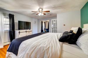 a bedroom with a large bed with a ceiling fan at Grand Home with Game Room - 16 Mi to Kalahari! in Gouldsboro