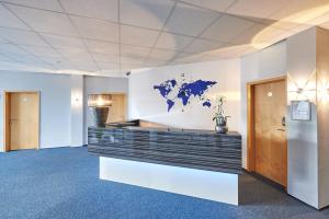 an office lobby with a map of the world on the wall at Komm' In Hotel in Mechernich