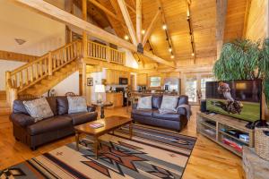 a living room with two couches and a tv at Waters Edge Retreat in Wagoner