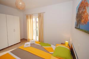 Postel nebo postele na pokoji v ubytování Red Sunset Apartments