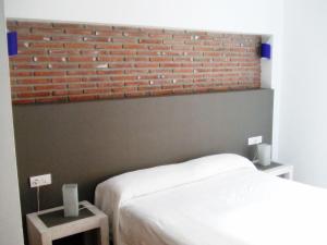 Posteľ alebo postele v izbe v ubytovaní Apartamentos Coronado