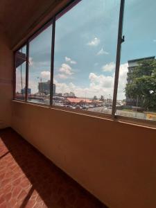 a room with a window with a view of a city at Warisan Family inn @ Seafront in Semporna