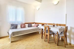 a living room with a couch and a table at Apartments Jera- barbecue in Sevid