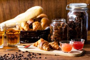 a table with a basket of bread and some drinks at Yamagata Grand Hotel in Yamagata