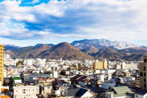 uma vista para uma cidade com montanhas ao fundo em Yamagata Grand Hotel em Yamagata