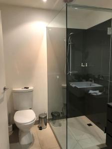 a bathroom with a toilet and a sink at Heart of Torquay - Whitewater Apartment - Torquay in Torquay