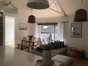 a living room with a couch and a table at Jetty Road Beach House in Rosebud