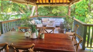 a wooden table and chairs on a deck at Magnetic Mango Escape in Horseshoe Bay