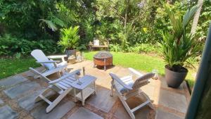 a group of chairs and a grill on a patio at Magnetic Mango Escape in Horseshoe Bay