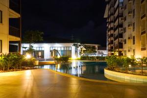 a pool in the middle of a city at night at An Oasis in Tagaytay - Serin in Tagaytay