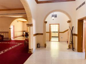a hallway with an archway in a building at Private Cottage in Sharjah