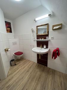 a bathroom with a sink and a toilet at Hotel Columbus und Glamping in Bremerhaven