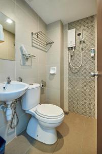 a bathroom with a toilet and a sink at Swing & Pillows - Adya Hotel Kuala Lumpur in Kuala Lumpur